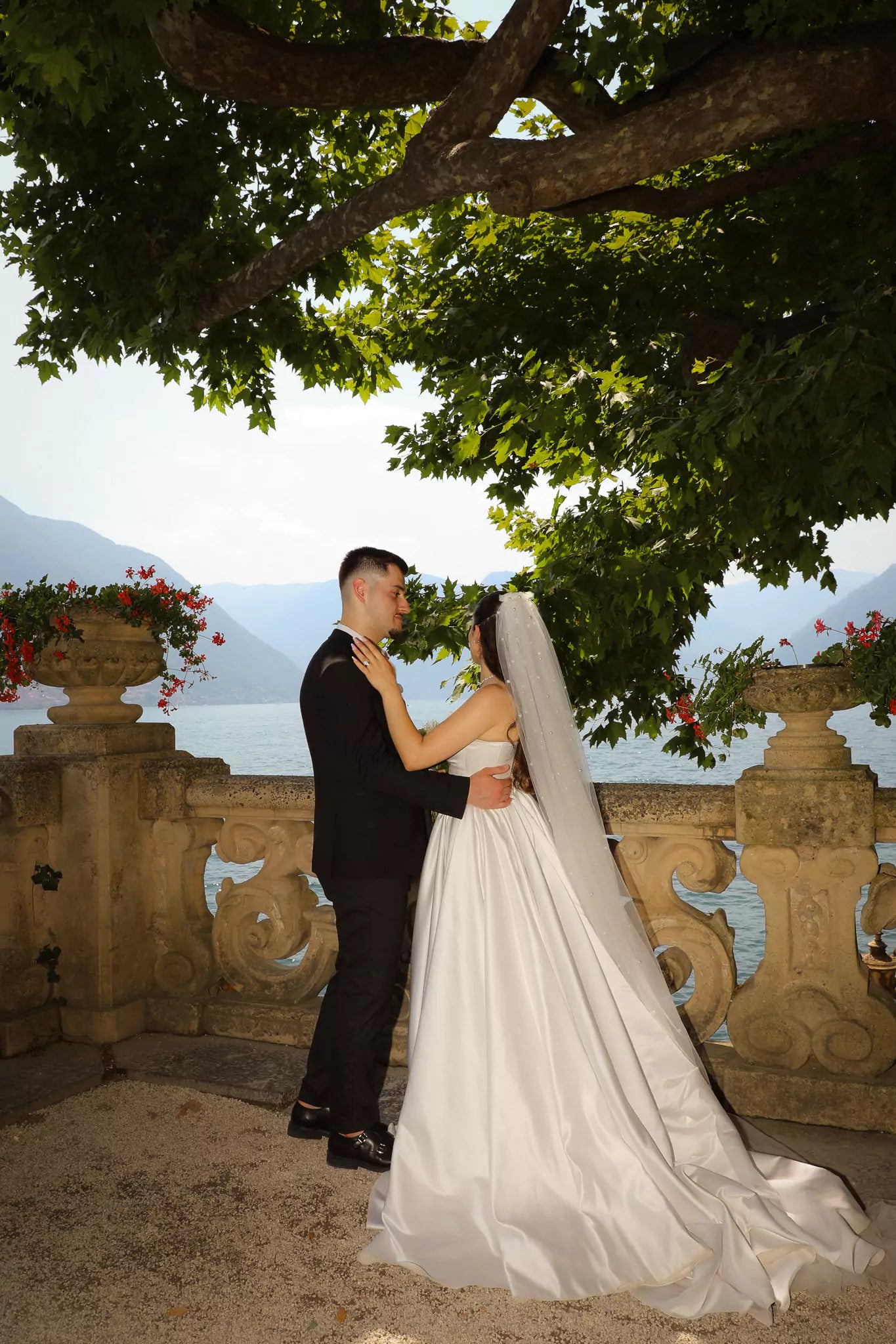 Bride and groom on the balcony of Villa del Balbianello with panoramic Lake Como views