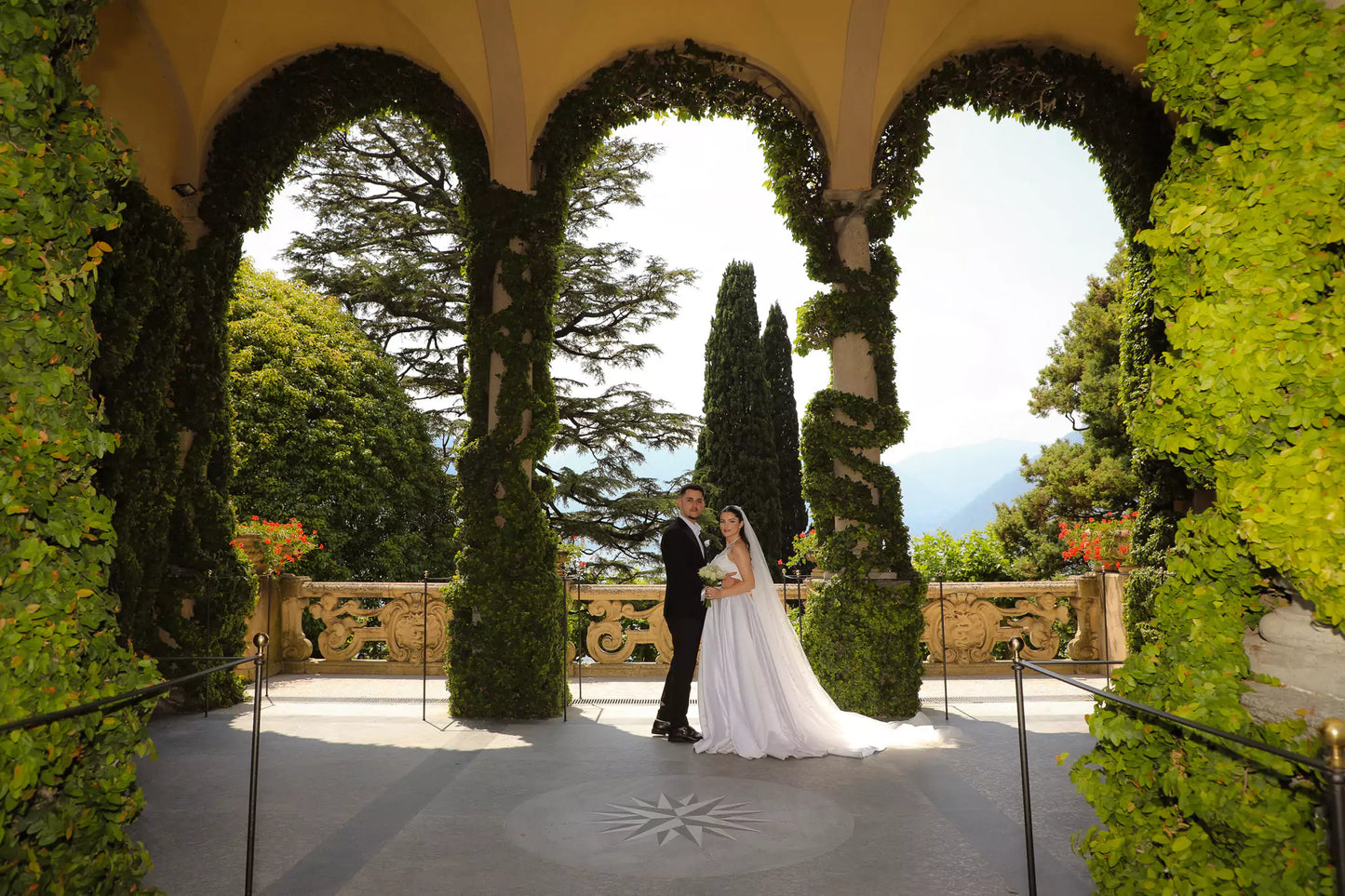 Bride and groom under the loggia at Villa del Balbianello during a luxury Lake Como wedding
